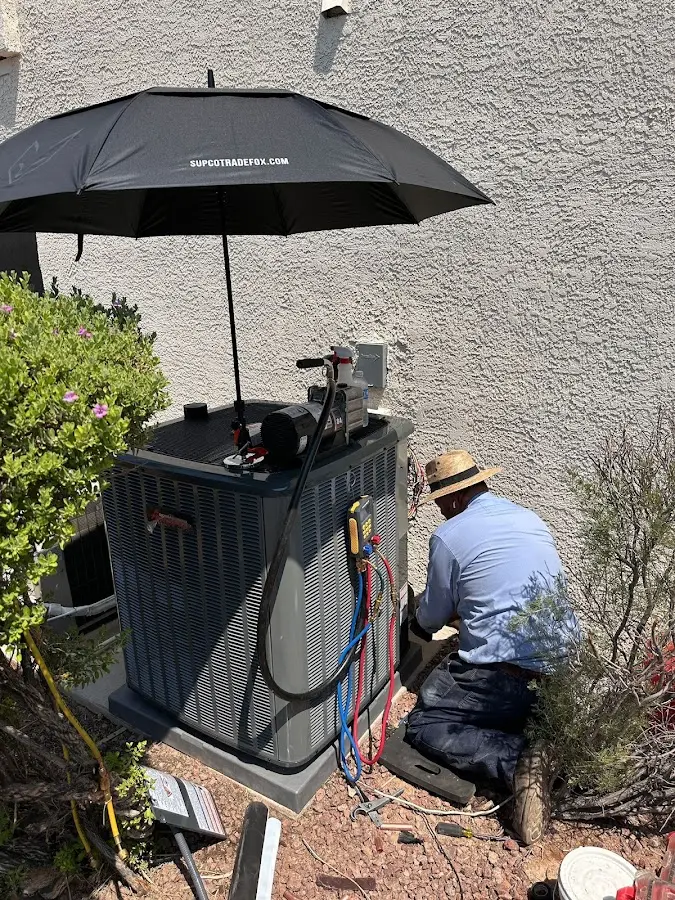 HVAC technician performing outdoor AC maintenance in New Bedford